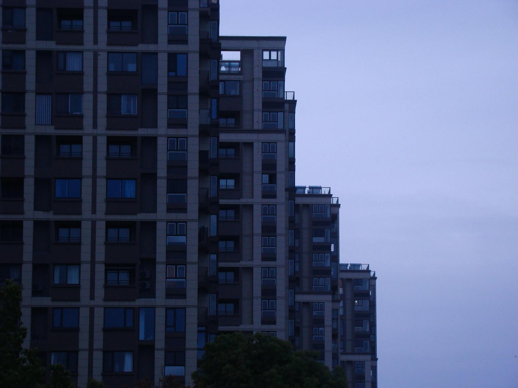 Nowoczesny wieżowiec na tle miasta o zmierzchu